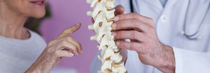 Chiropractic Kailua-Kona HI Woman And Doctor Looking At Spine Model FAQ